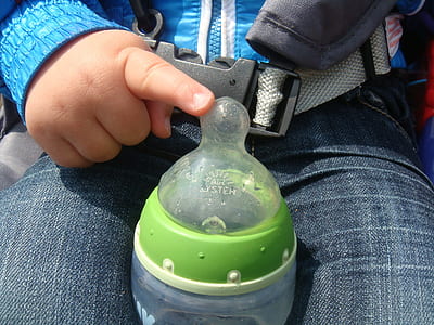toddler holding feeding bottle thumbnail