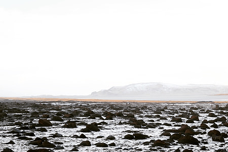 landscape photo of jagged rock on body of water thumbnail