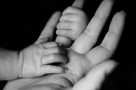 baby holding woman's hand thumbnail