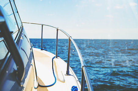 white yacht on body of water undey gray sky during daytime thumbnail