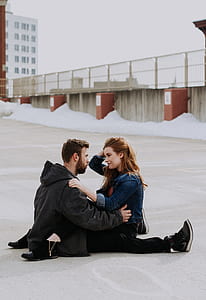 man and woman sitting on ground thumbnail