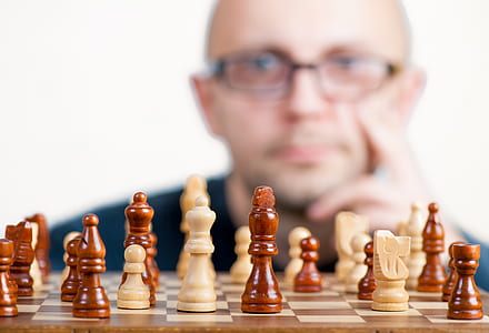 shallow focus of chess board behind of man thumbnail