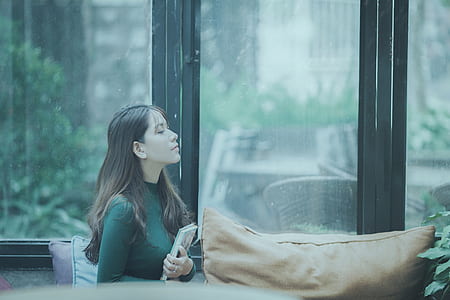woman wearing green top handling book thumbnail