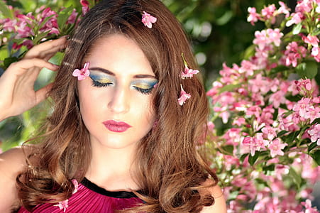 woman wearing pink top with pink flowers on hair thumbnail