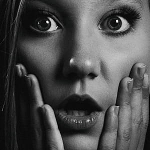 Grayscale Photo of Woman Holding Her Face thumbnail