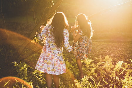photography of two women in floral dress surrounded by plants thumbnail