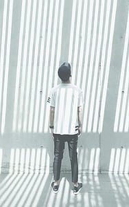 man standing in front of wall thumbnail