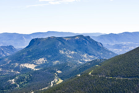 tree covered mountains during day thumbnail