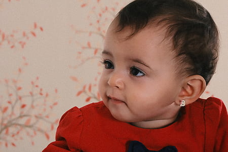 Baby Wearing Red Crew-neck Shirt Near Pink and Black Floral Surface thumbnail