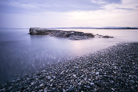 rock formation on body of water thumbnail
