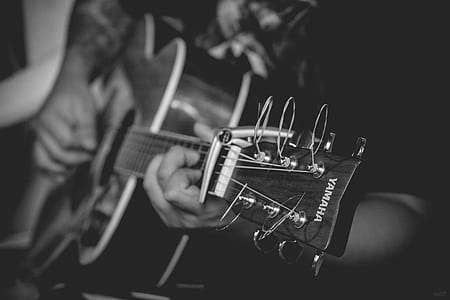 grayscale photo of person playing guitar thumbnail