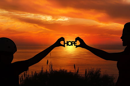 silhouette of people holding HOPE logo during sunset thumbnail
