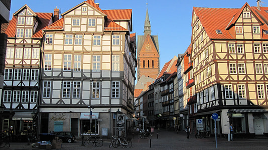 white and orange mid-rise building near clock tower thumbnail