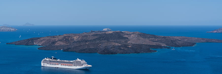 White Crewship Near Island Under Clear Sky at Daytime thumbnail