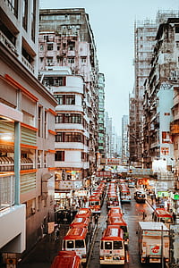 vehicles passing on road near buildings thumbnail