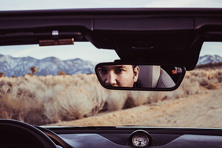 man looking at the vehicle rear mirror thumbnail