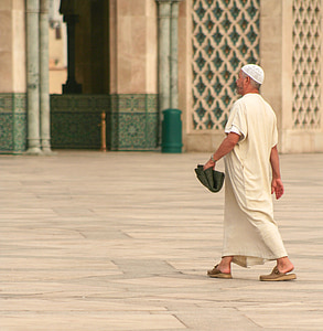 monk walking on white floor thumbnail