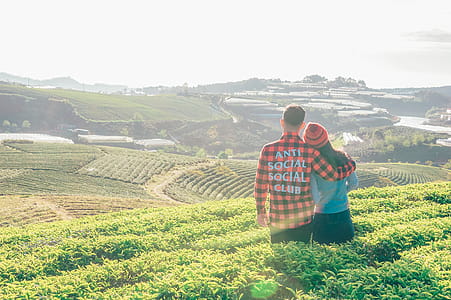 Man and Woman Looking at Grass Field thumbnail