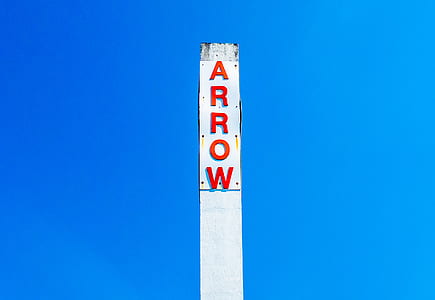 Arrow signage under blue sky thumbnail