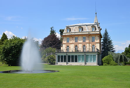 beige and white house near green leafed trees thumbnail