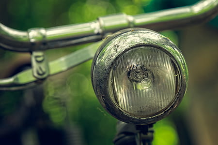 close-up photo of round gray bicycle headlight thumbnail