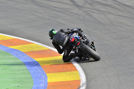 person riding on sports bike on race track thumbnail
