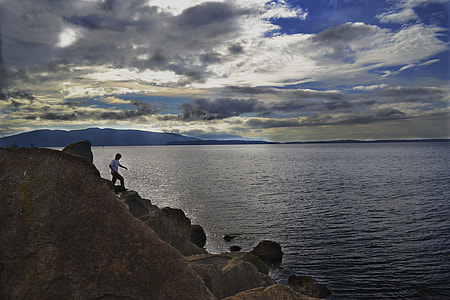 man standing on boulder thumbnail
