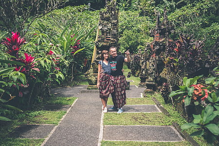 Woman and Man Standing Together and Looking on Flower Garden thumbnail