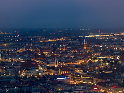 aerial view of buildings with lights during nighttime thumbnail