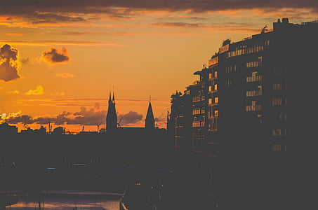 silhouette of concrete buildings during golden hour photo thumbnail