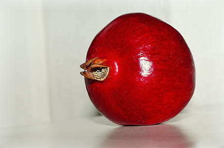 red pomegranate on table thumbnail