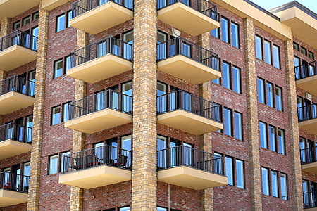 brown and yellow high-rise building during daytime thumbnail