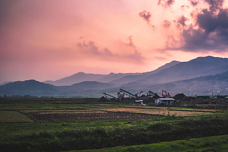 green grass land surrounded with mountains thumbnail