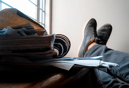 man's feet on top of table thumbnail