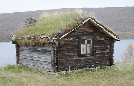 brown wooden house on mountain top with grasses during daytime thumbnail