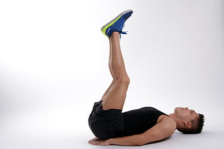 man in black tank top lying on white surface raising his legs thumbnail