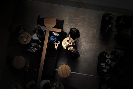 people sitting on table beside chairs inside rooms thumbnail