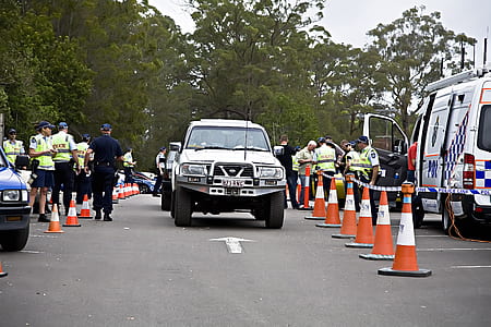 white Nissan truck on road with surrounding policemen thumbnail