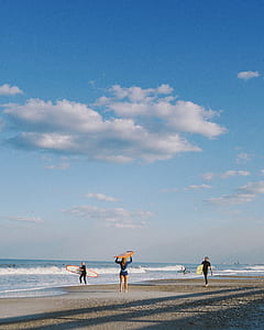 woman holding surfboard thumbnail