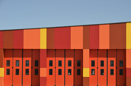 architectural photography of red wooden doors thumbnail