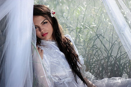 woman wearing dress leaning on wall near the grass thumbnail
