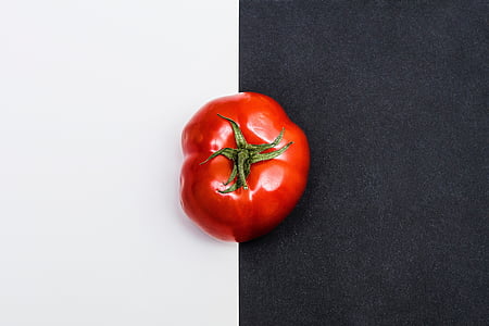 red heirloon tomato on white and black surface thumbnail