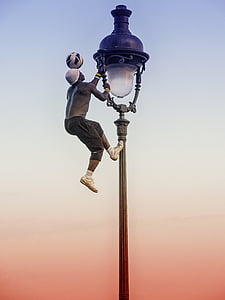 man wearing gray sweat shorts holding tower lamp thumbnail