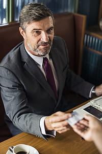 Man Sitting on Brown Chair thumbnail