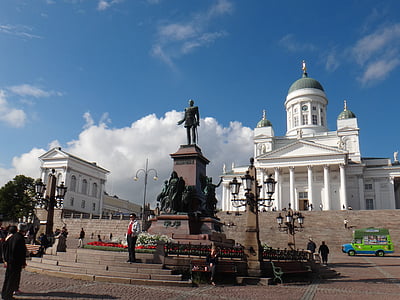 statue near white building thumbnail