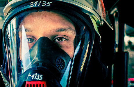 person wearing black gas mask inside room thumbnail