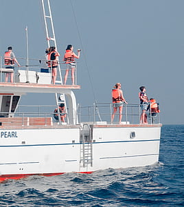 man and woman on top of white ship thumbnail