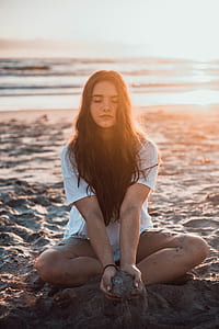 woman wearing white t-shirt on gray sand thumbnail