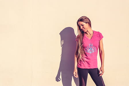 Woman in Pink V-neck Cap-sleeved Shirt Standing Near Wall thumbnail