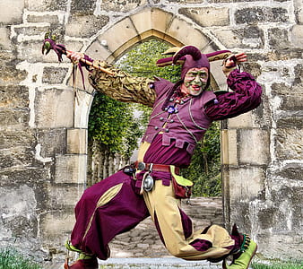 man wear costume posing near concrete wall thumbnail
